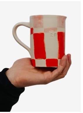A red checkered mug